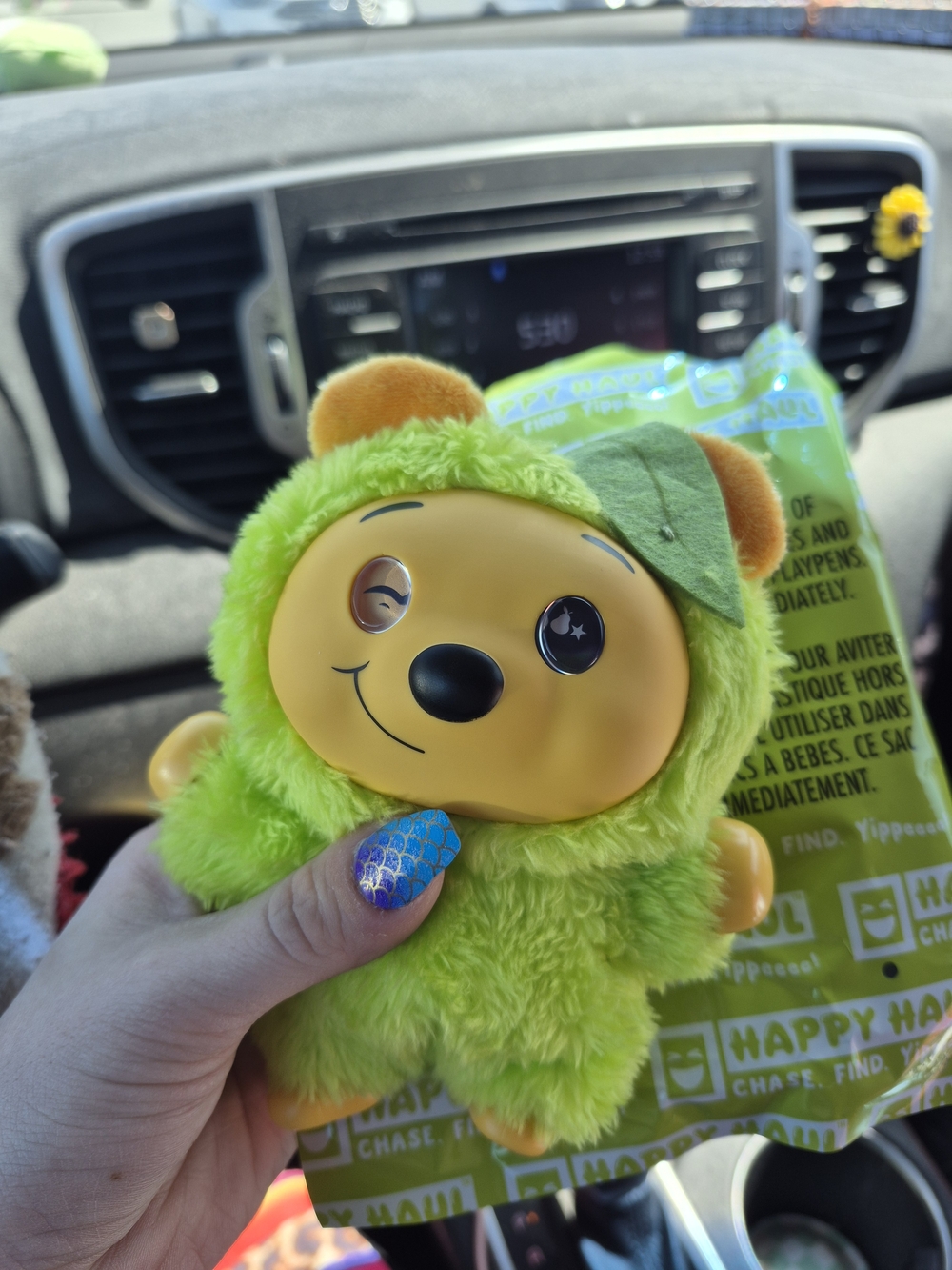 Green Plush Character Toy with Smiling Face